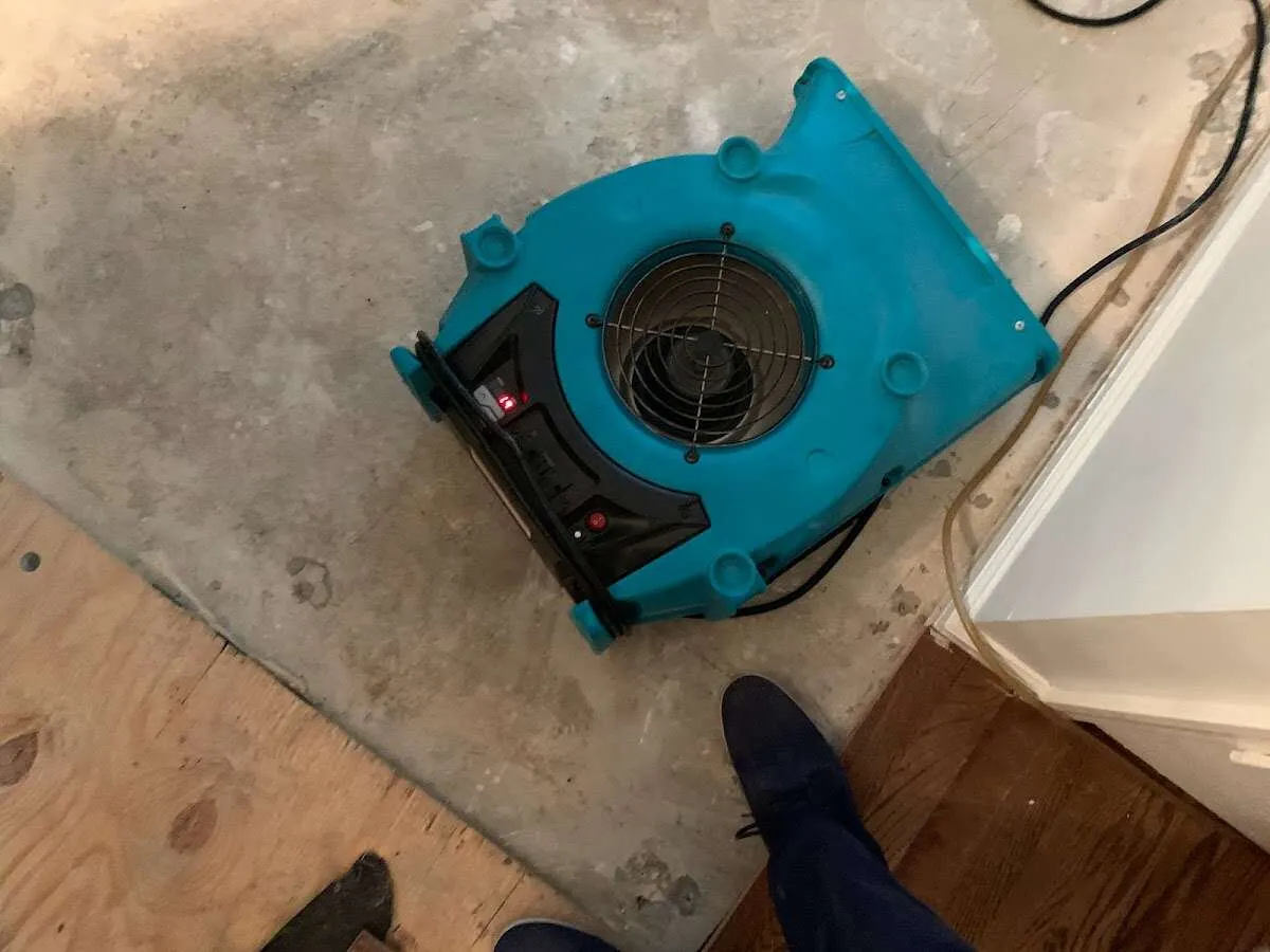 Air mover drying subfloor during Leak Detection & Repair in Overland